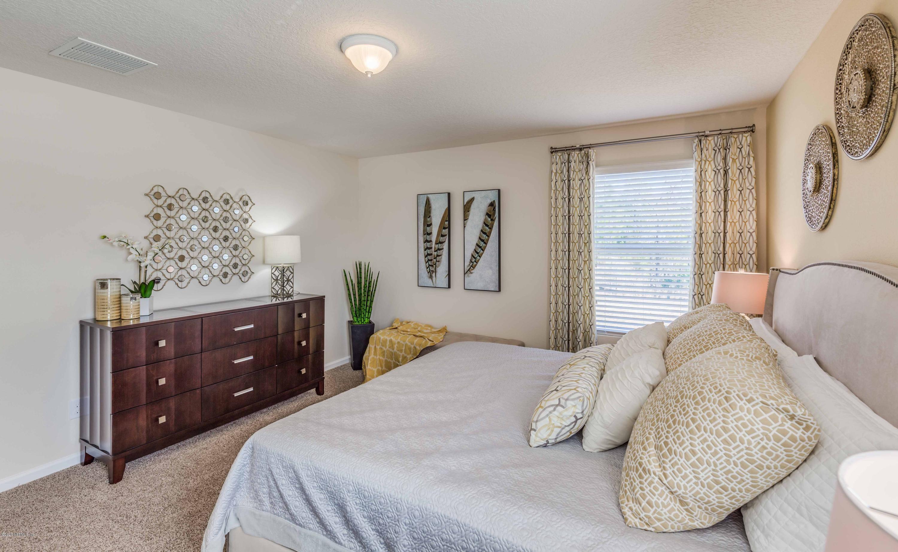 3820 Great Falls Loop Middleburg, FL 32068 - Photo 27 of 36 a bedroom with a bed and a painting on the wall