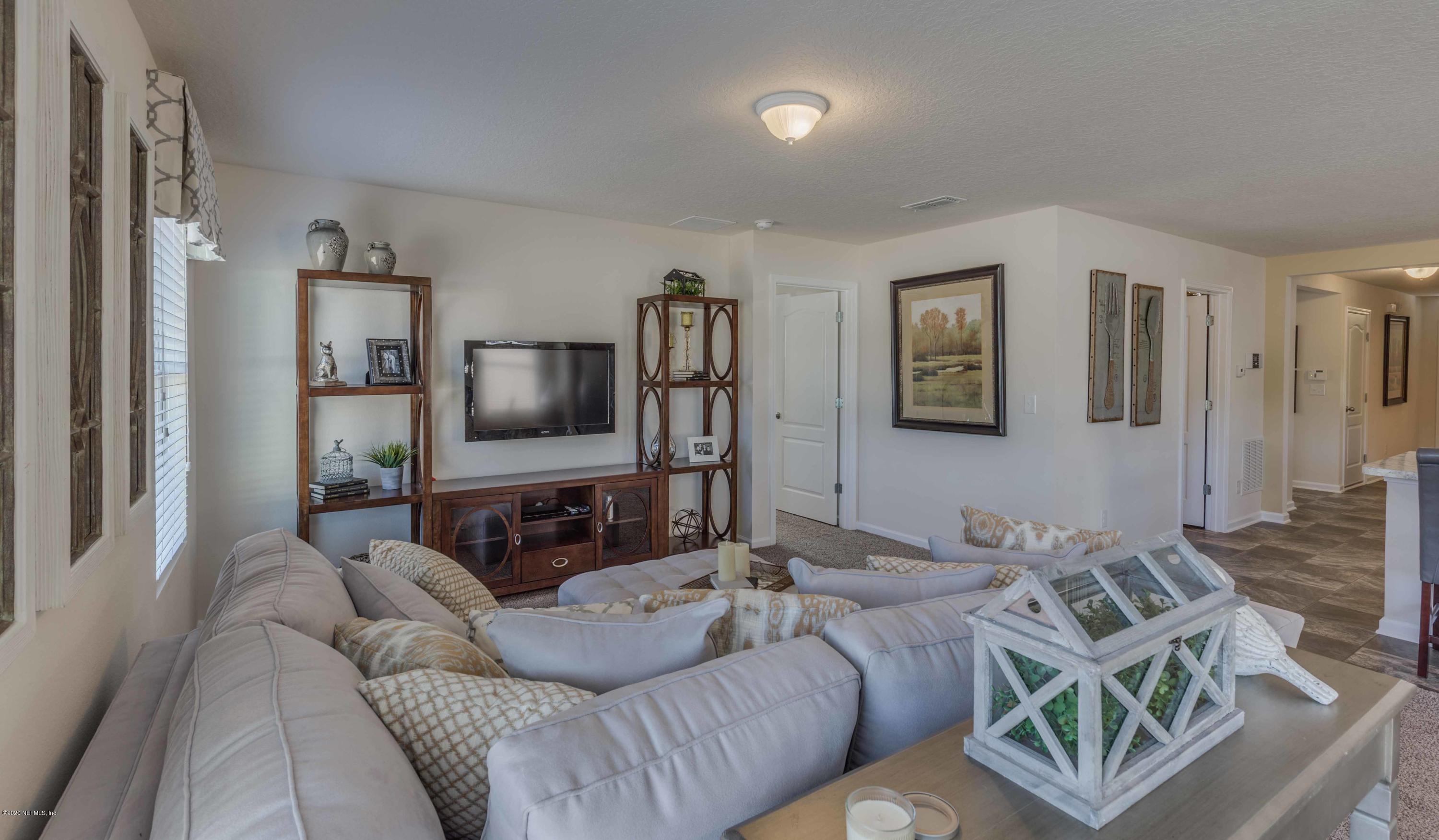 3820 Great Falls Loop Middleburg, FL 32068 - Photo 7 of 36 a living room with furniture and a flat screen tv