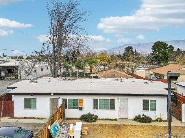a aerial view of a house with a yard table and chairs