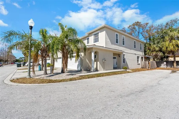 a view of a house with palm trees