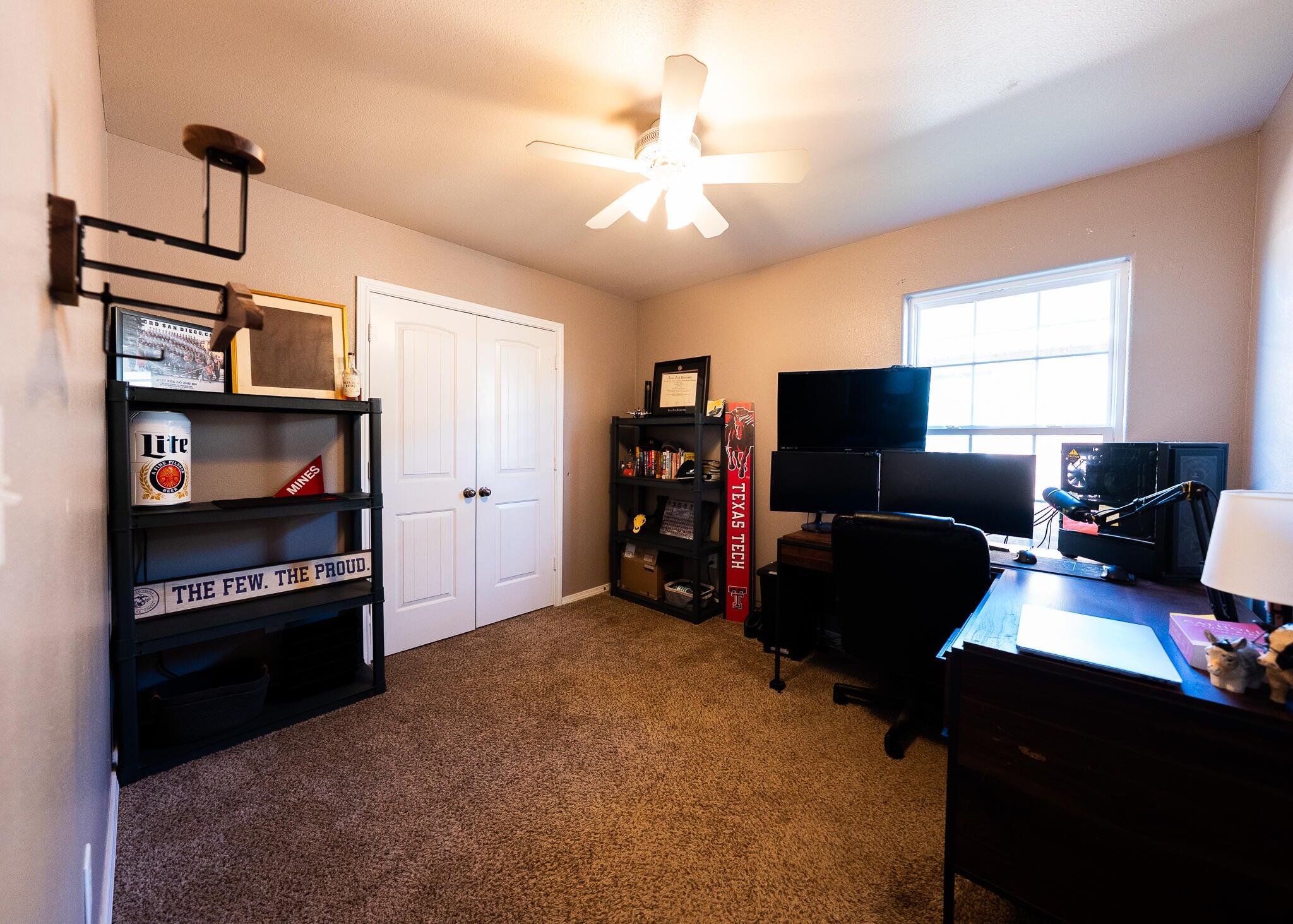 9104 Quincy Avenue Lubbock, TX 79424 - Photo 12 of 15 a room with furniture and a flat screen tv