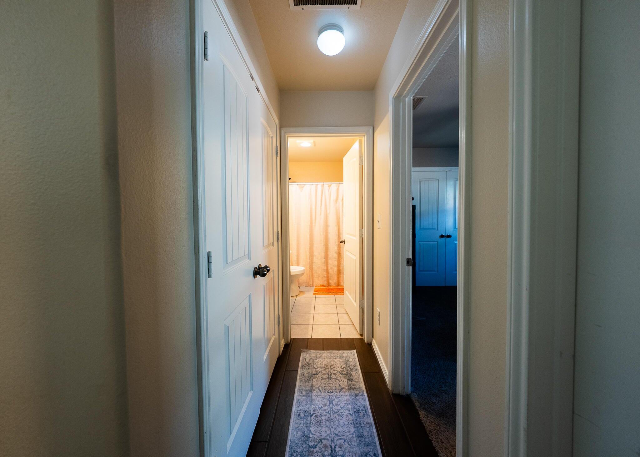 9104 Quincy Avenue Lubbock, TX 79424 - Photo 9 of 15 a view of hallway with wooden floor
