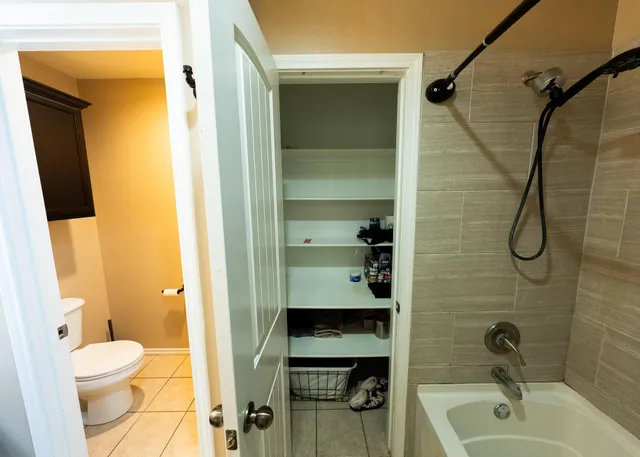 a bathroom with a sink a toilet and shower curtain