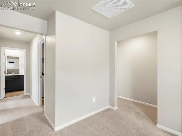 a view of a hallway with closet and bathroom