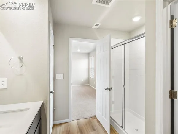 a bathroom with a shower and a sink