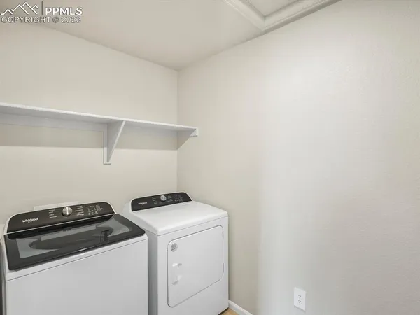 a view of storage and utility room with washer and dryer