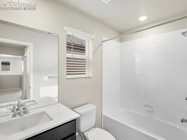 a bathroom with a sink toilet a mirror and shower
