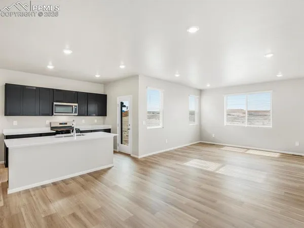 a view of a kitchen with stainless steel appliances kitchen island