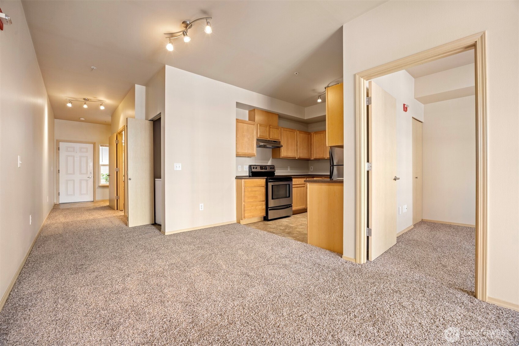 1031 North State Street, Unit 107 Bellingham, WA 98225 - Photo 11 of 33 a view of a kitchen with refrigerator and a sink