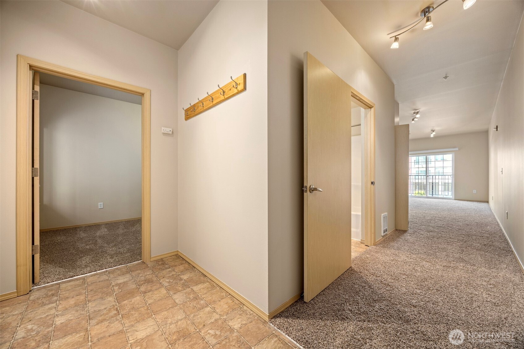1031 North State Street, Unit 107 Bellingham, WA 98225 - Photo 20 of 33 a view of a hallway with closet and wooden floor