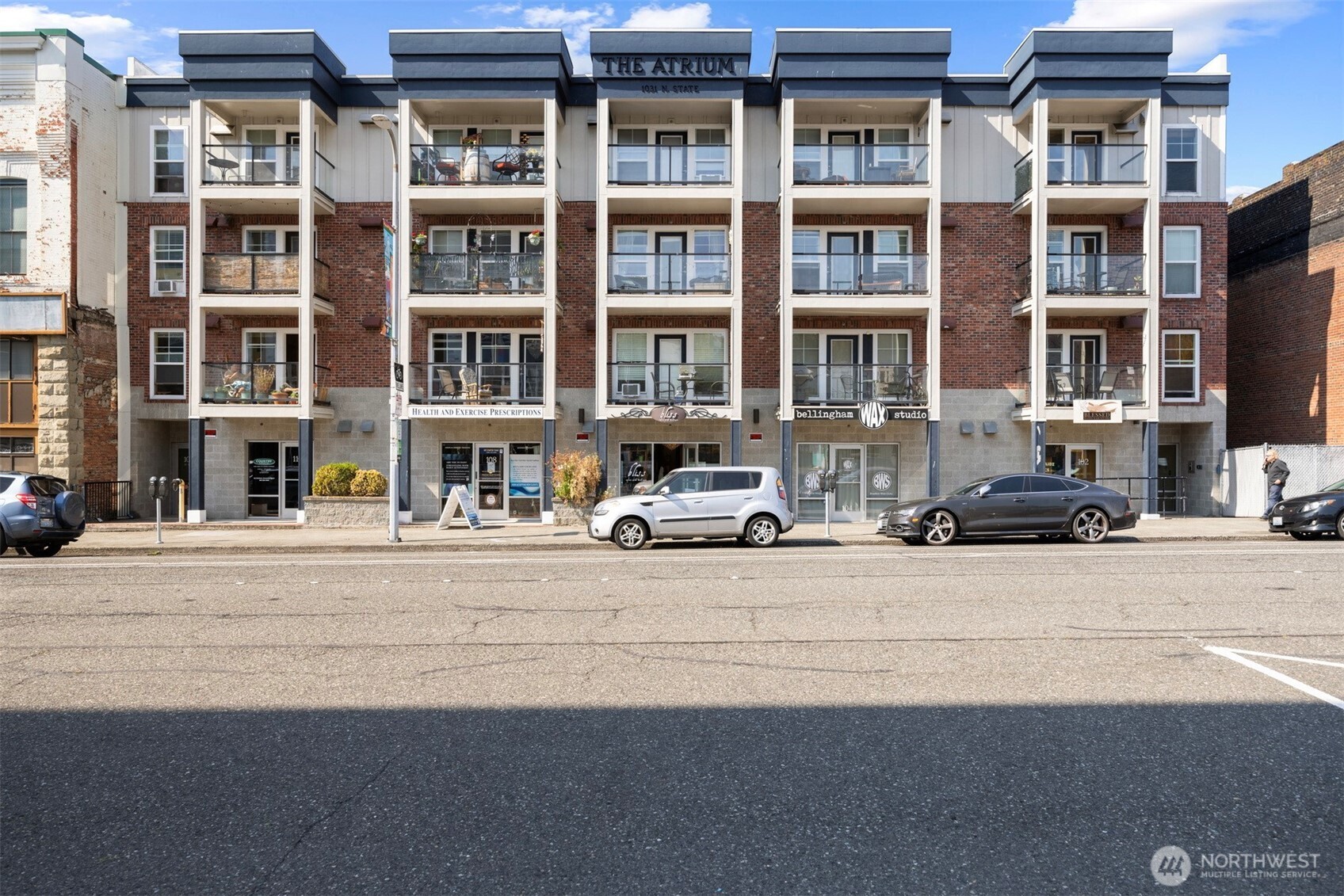 1031 North State Street, Unit 107 Bellingham, WA 98225 - Photo 3 of 33 a front view of a building with a yard