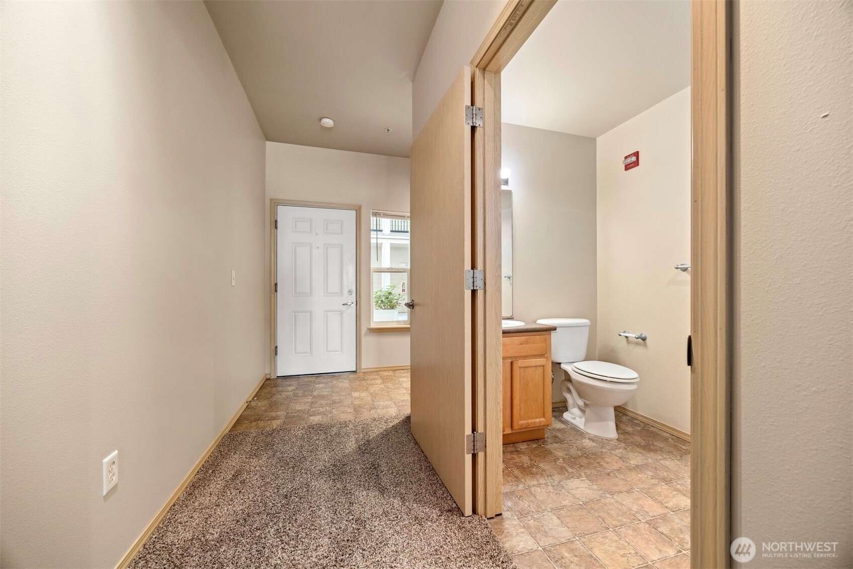 1031 North State Street, Unit 107 Bellingham, WA 98225 - Photo 8 of 33 a bathroom with a toilet sink and a view of bathroom