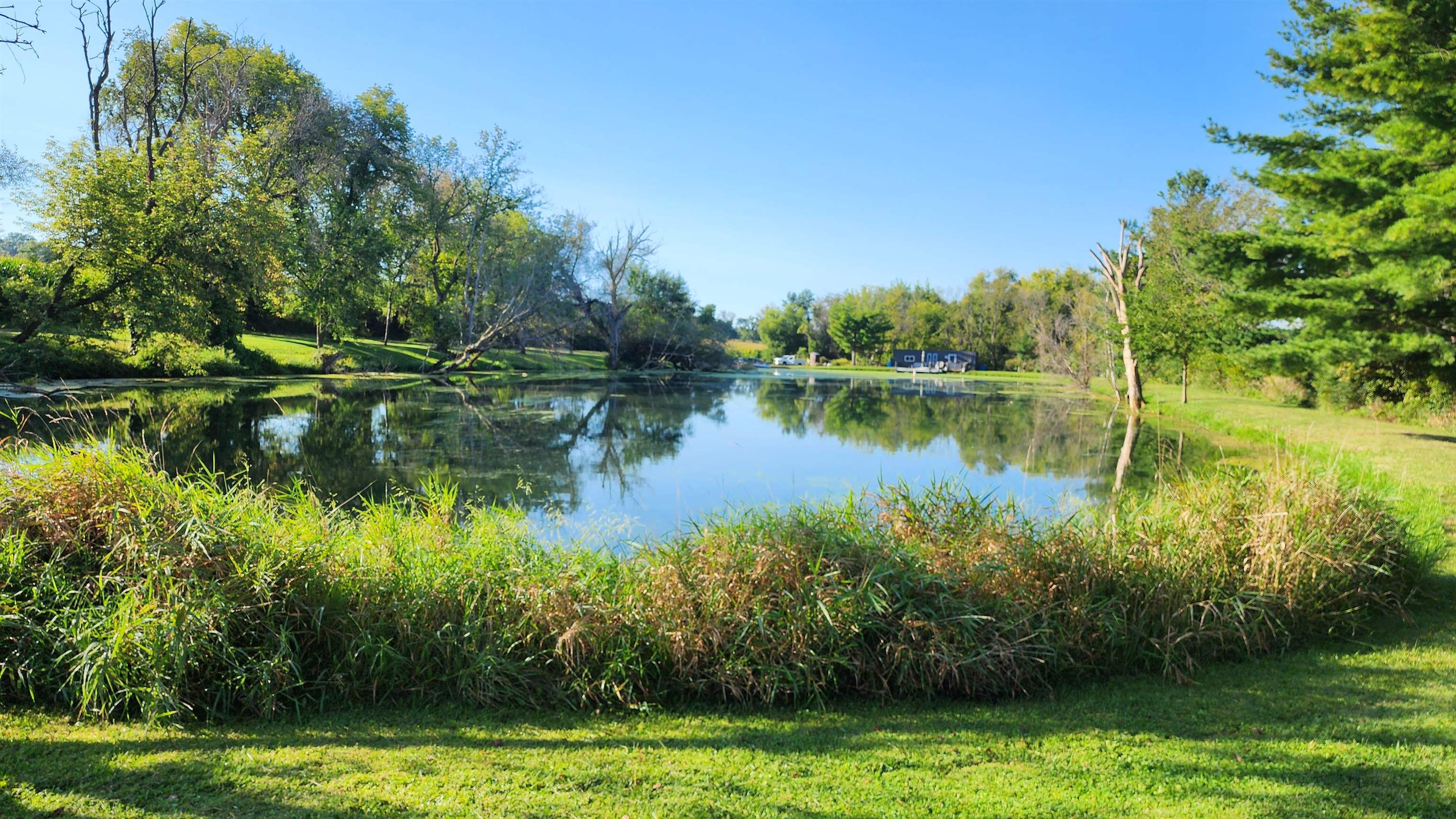 0 North Pecatonica Road Pecatonica, IL 61063 - Photo 18 of 24 a view of a lake with a yard and large trees