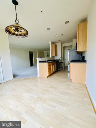 a view of a kitchen with a sink stainless steel appliances and cabinets
