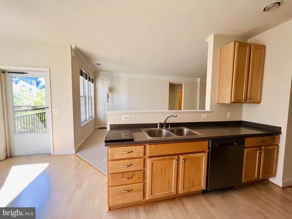 a kitchen with granite countertop a sink and a wooden cabinets