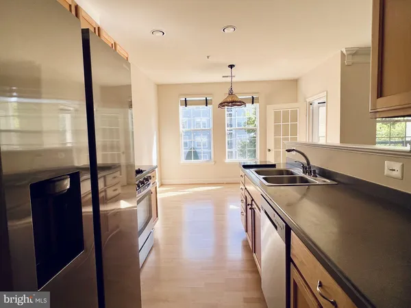 a open kitchen with stainless steel appliances granite countertop a sink stove and refrigerator