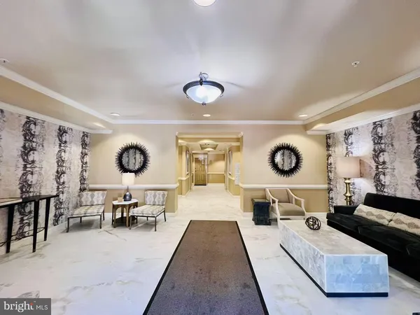 a living room with furniture and a clock on dresser next to a window