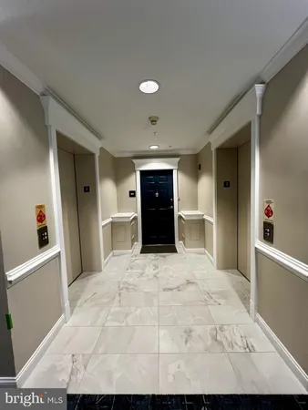 a large white bedroom with a large bed and dresser