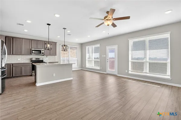a view of kitchen with cabinets and wooden floor