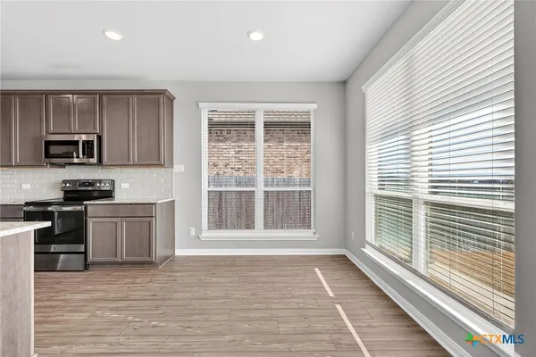 a kitchen with a stove a sink and a microwave
