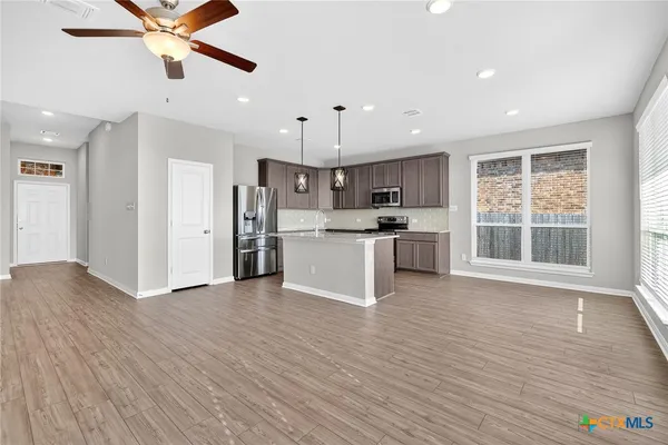 a view of kitchen with cabinets and wooden floor