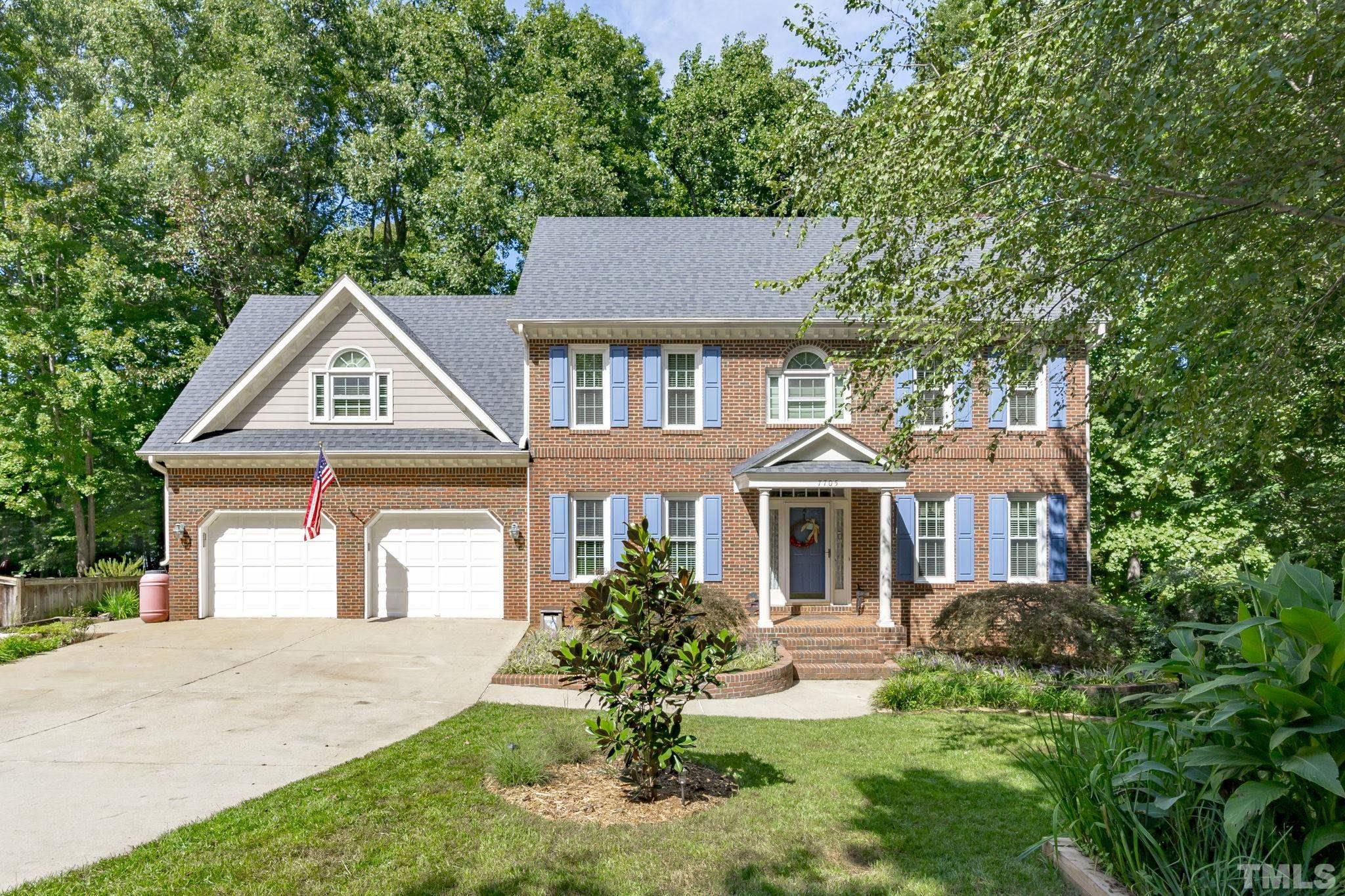 7705 Tylerton Drive Raleigh, NC 27613 - Photo 1 of 35 a front view of a house with a yard and garage
