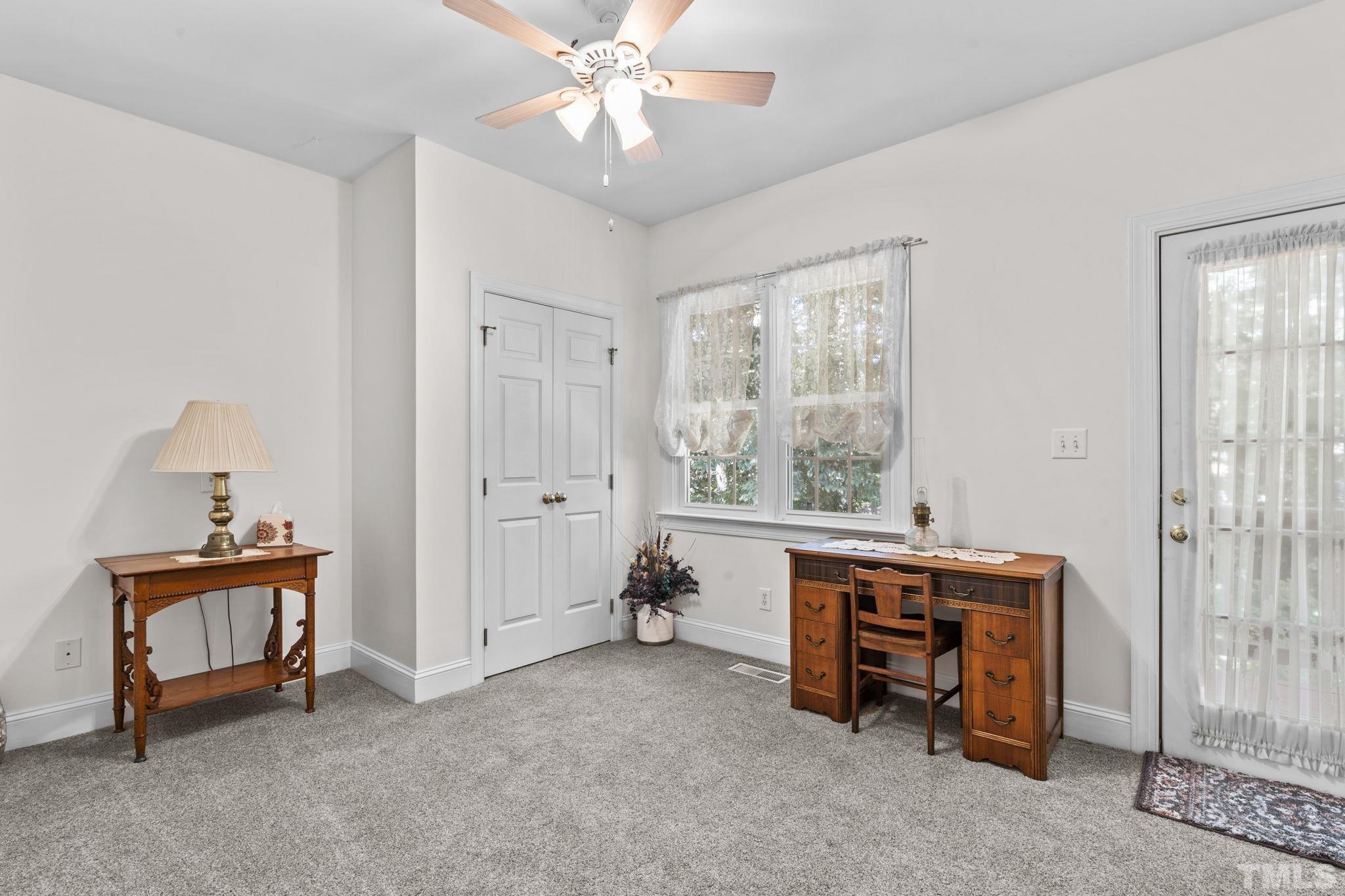 7705 Tylerton Drive Raleigh, NC 27613 - Photo 13 of 35 a room with furniture and a chandelier