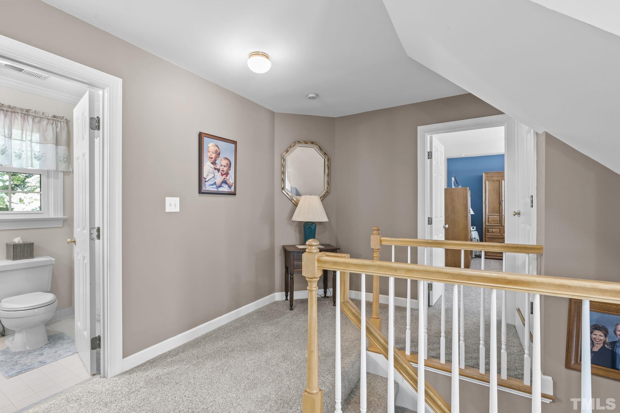 7705 Tylerton Drive Raleigh, NC 27613 - Photo 14 of 35 a view of a hallway with a livingroom and windows