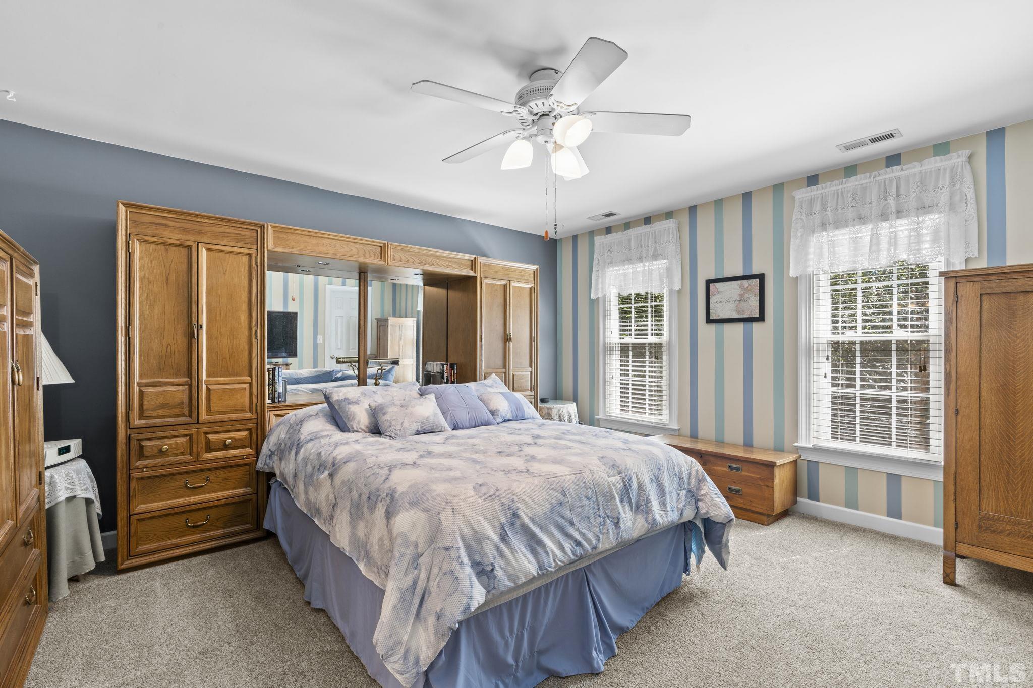 7705 Tylerton Drive Raleigh, NC 27613 - Photo 15 of 35 a bedroom with a bed and a large window