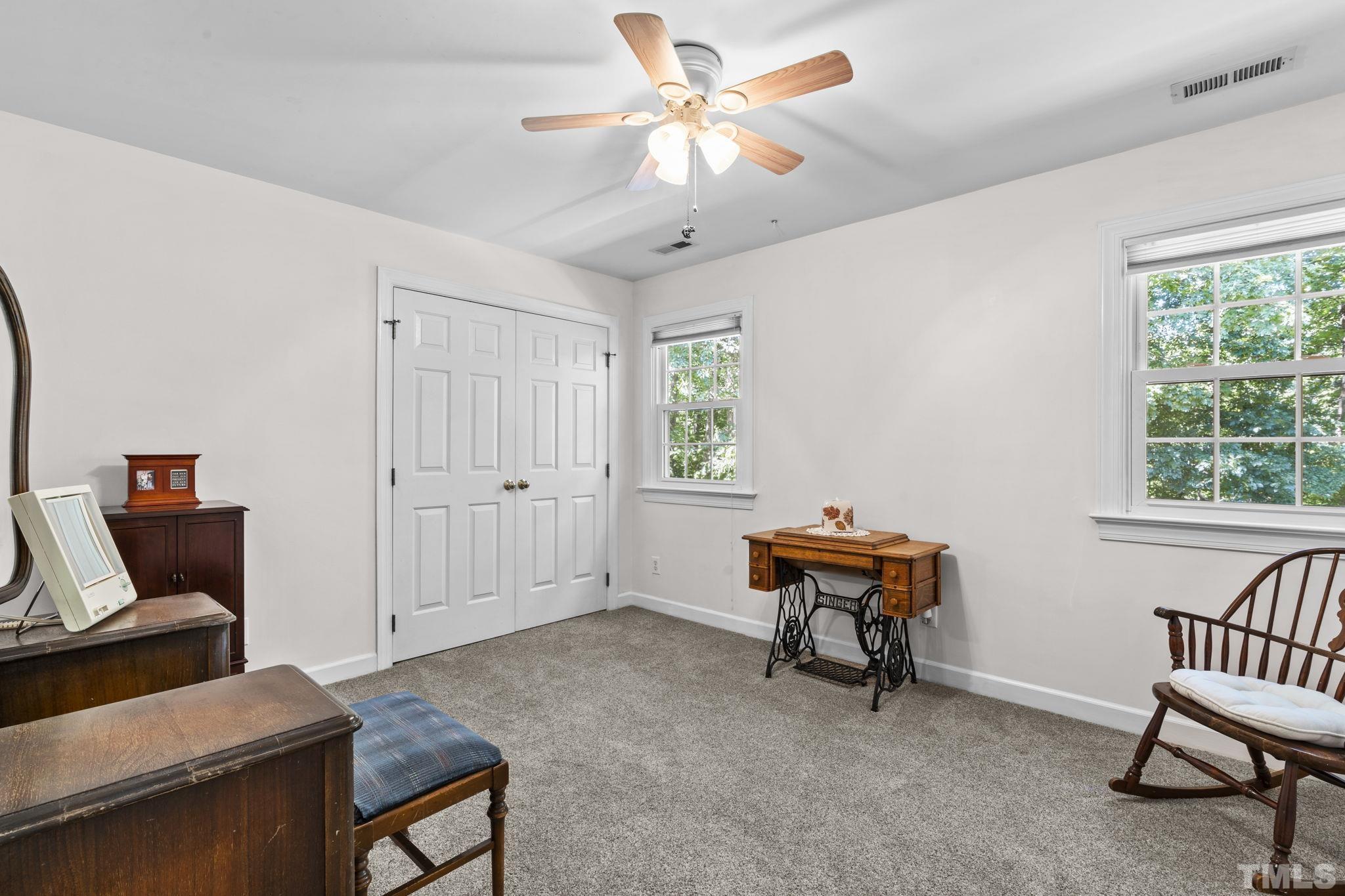 7705 Tylerton Drive Raleigh, NC 27613 - Photo 19 of 35 a living room with furniture and a window