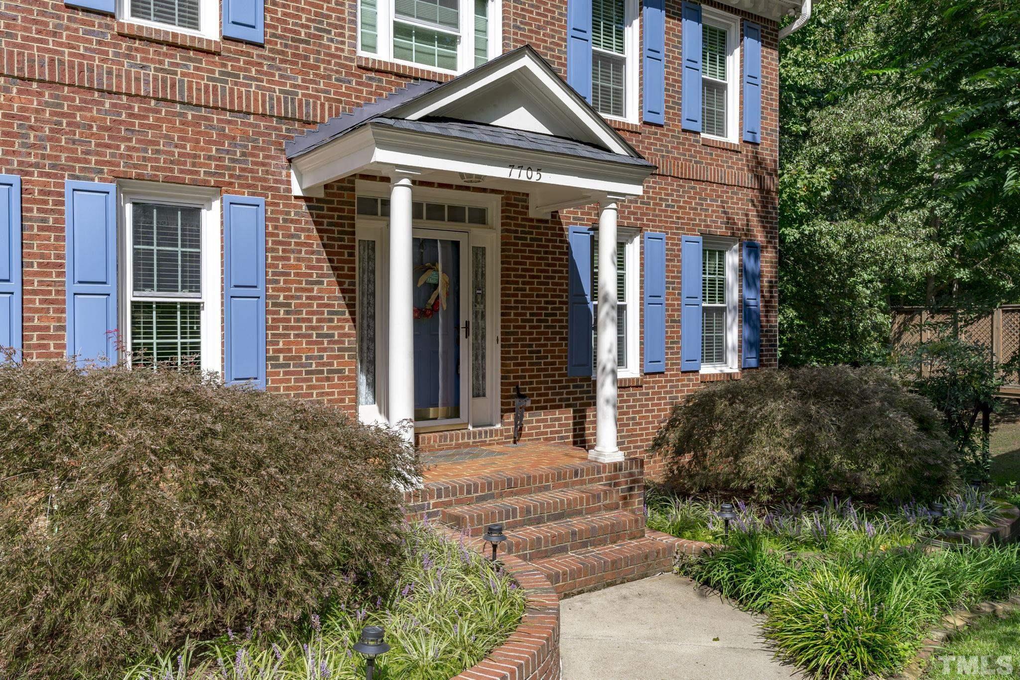 7705 Tylerton Drive Raleigh, NC 27613 - Photo 2 of 35 a front view of a house with garden