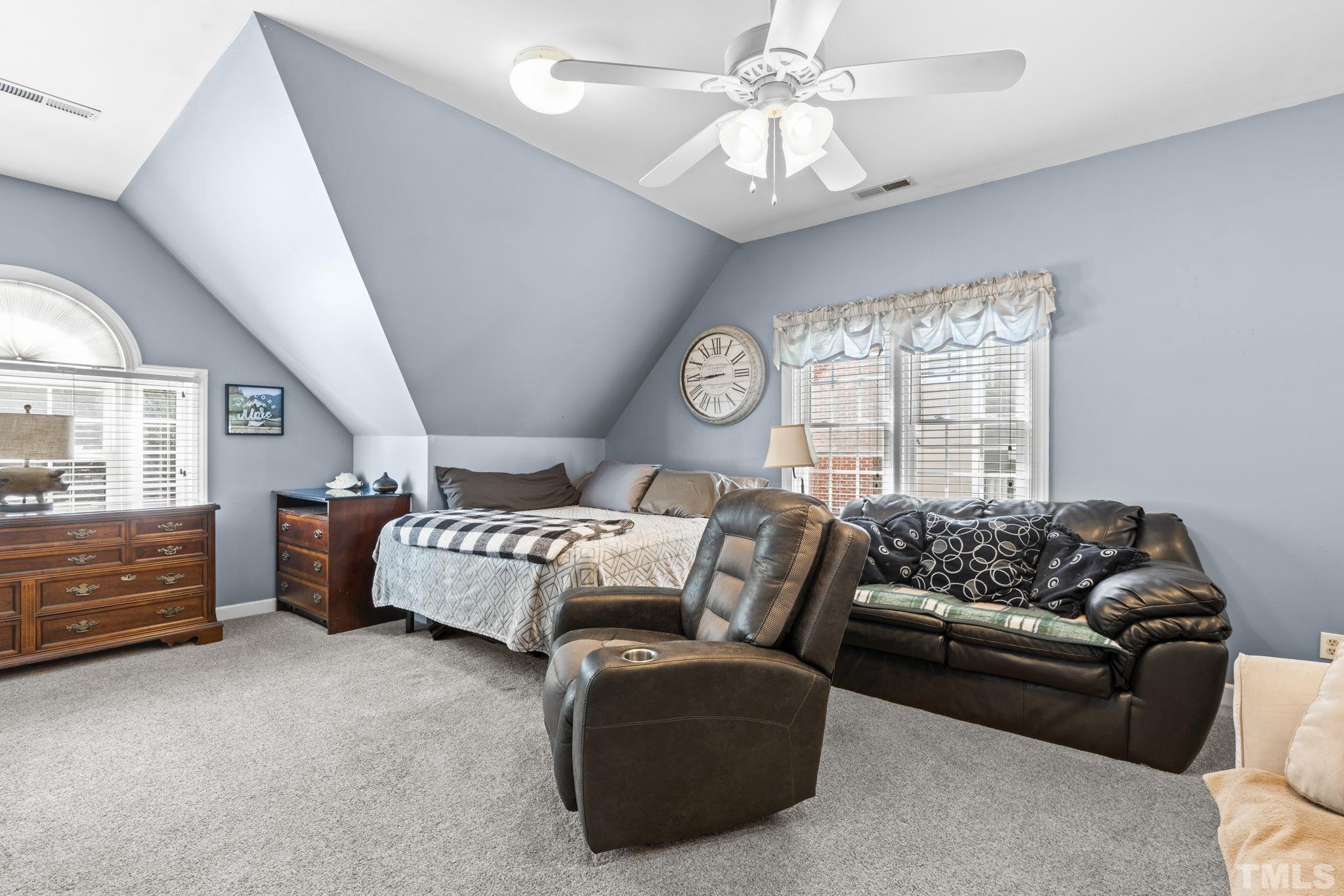 7705 Tylerton Drive Raleigh, NC 27613 - Photo 21 of 35 a bedroom with furniture and a large window