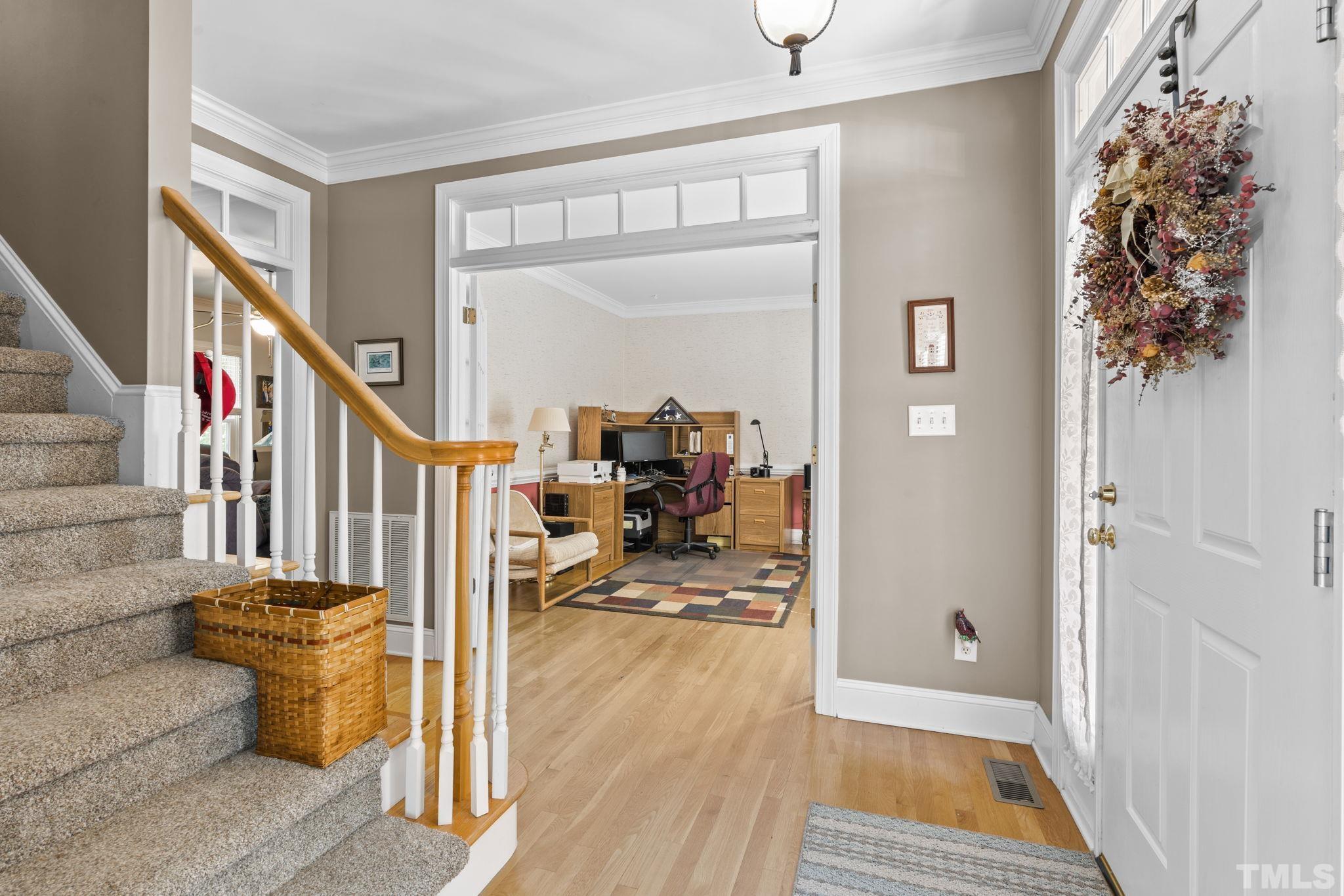 7705 Tylerton Drive Raleigh, NC 27613 - Photo 3 of 35 a view of entryway with wooden floor
