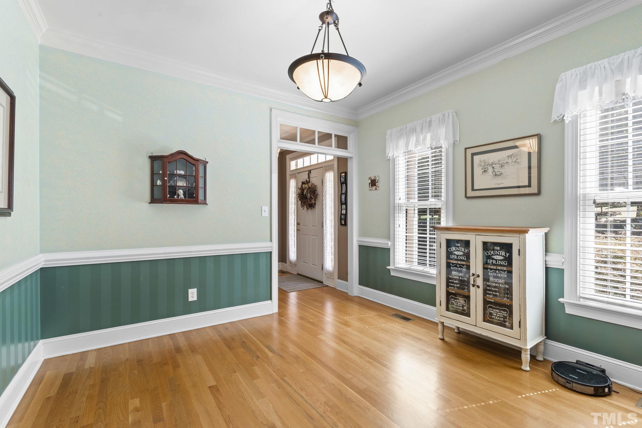 7705 Tylerton Drive Raleigh, NC 27613 - Photo 5 of 35 a view of livingroom with hardwood floor and window