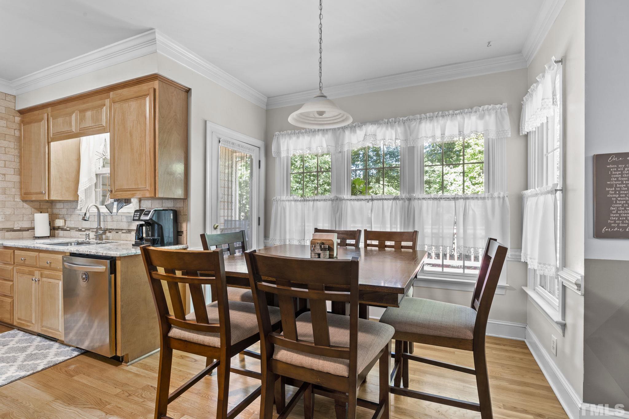7705 Tylerton Drive Raleigh, NC 27613 - Photo 9 of 35 a view of a dining room with furniture window and outside view