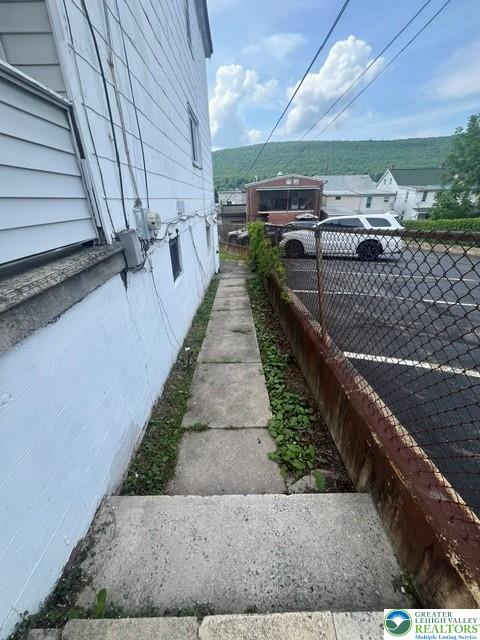 80 West Center Street Nesquehoning, PA 18240 - Photo 5 of 5 A long concrete pathway borders the property, offering a convenient side entry.