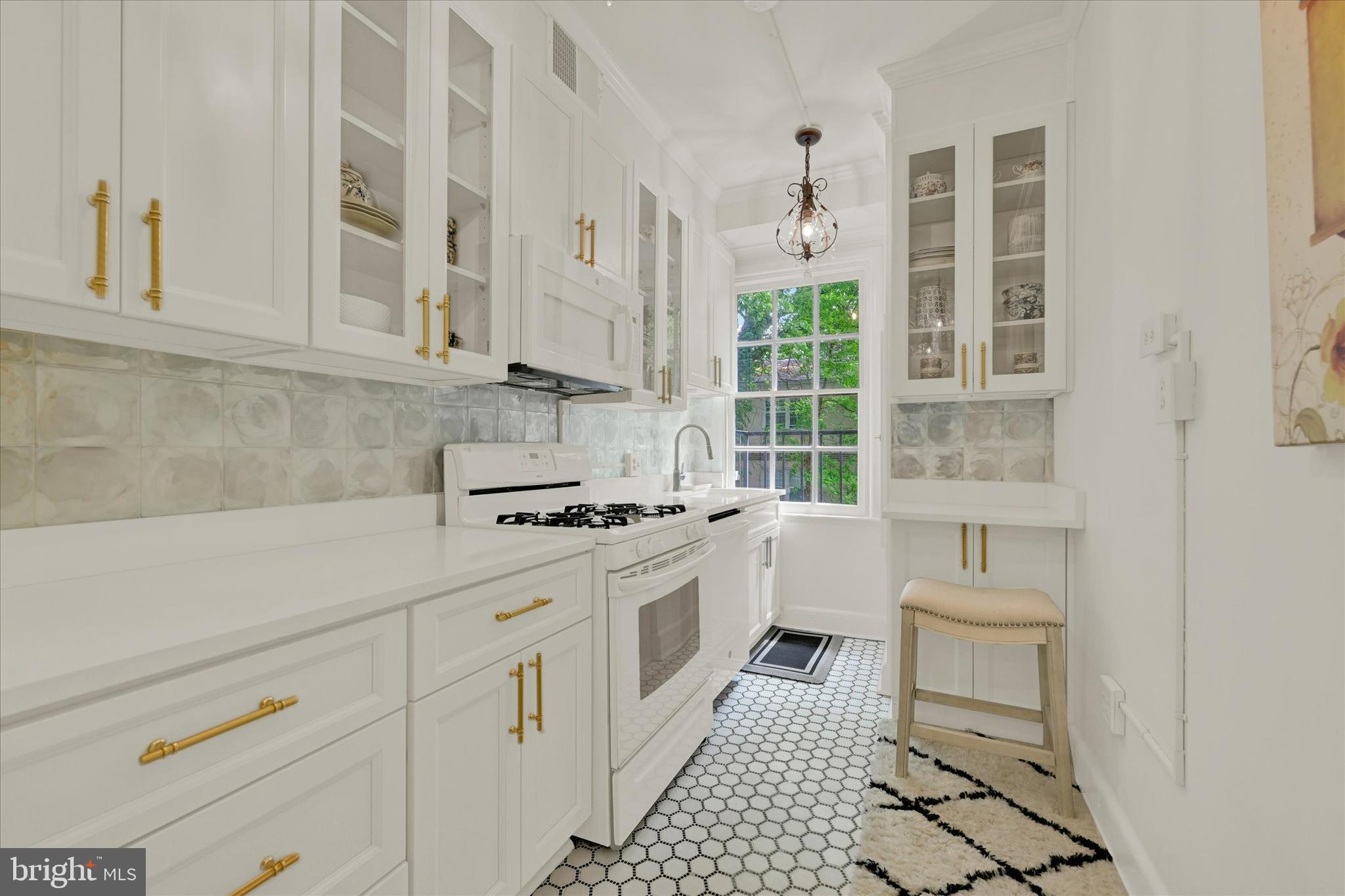 6 Upland Road, Unit Q3 Baltimore, MD 21210 - Photo 12 of 27 a kitchen with white cabinets and white appliances