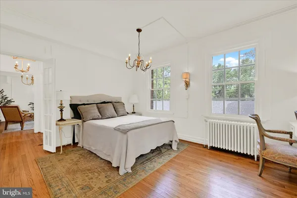 a bed room with a bed and a chair