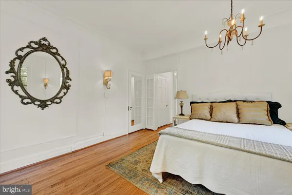 a bedroom with a bed and a mirror