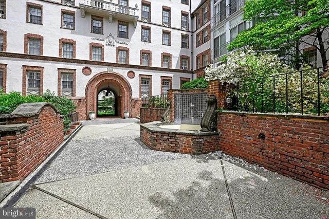 a front view of a multi story building with yard