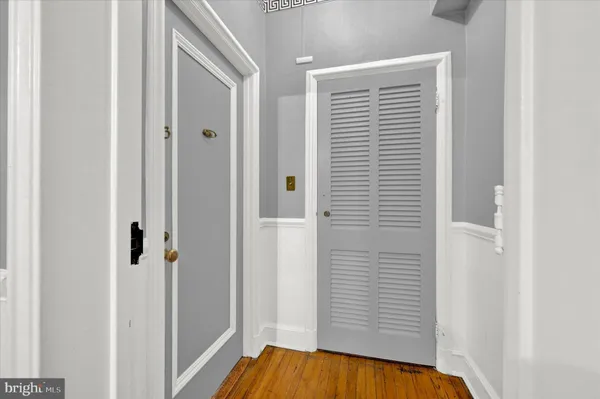 a view of a hallway with wooden floor and staircase