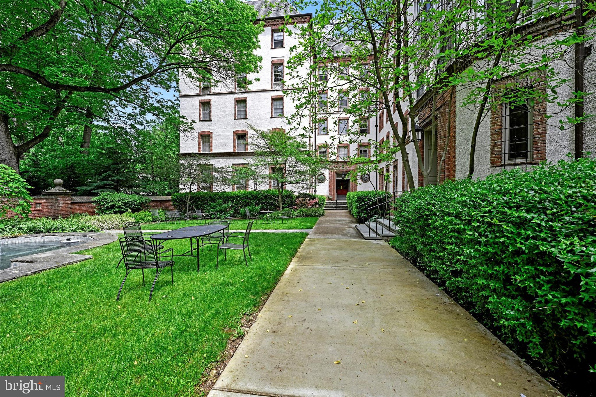 6 Upland Road, Unit Q3 Baltimore, MD 21210 - Photo 24 of 27 a view of a white house with a yard and potted plants