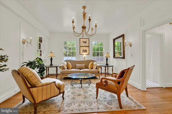a living room with furniture a dining table and a window