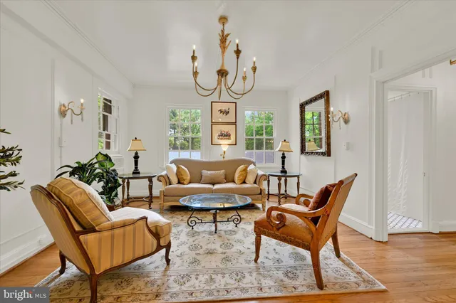 a living room with furniture a dining table and a window