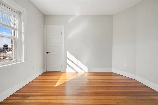 a view of a room with wooden floor and staircase