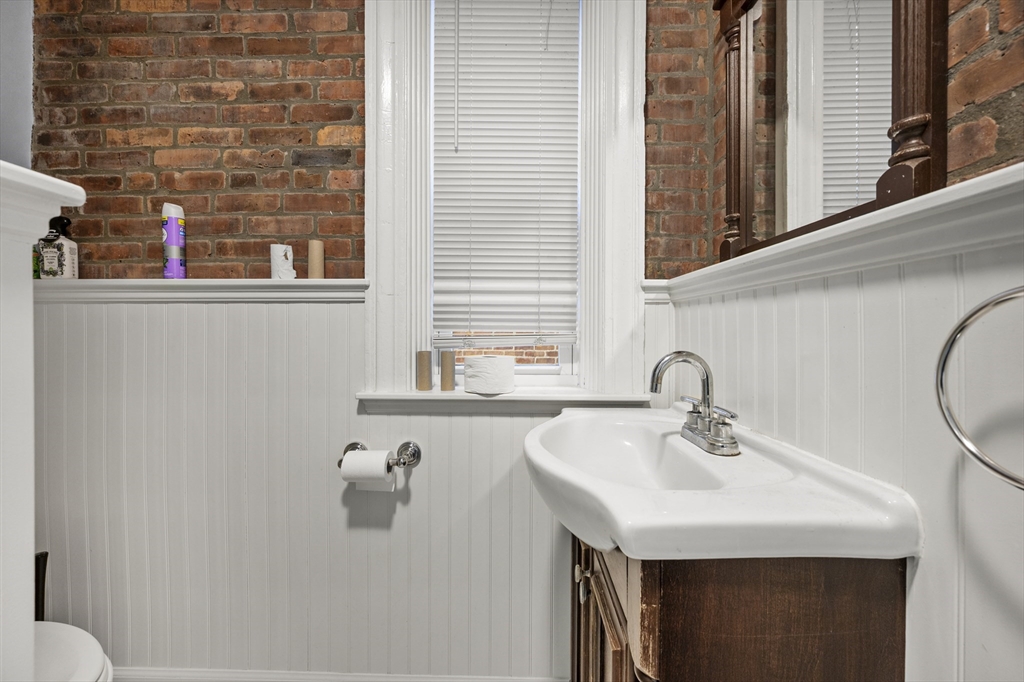 493 Broadway, Unit 2 Somerville, MA 02145 - Photo 17 of 24 a bathroom with a sink and a mirror