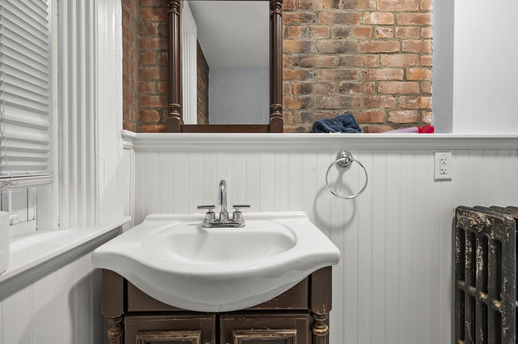 493 Broadway, Unit 2 Somerville, MA 02145 - Photo 18 of 24 a bathroom with a sink and a mirror