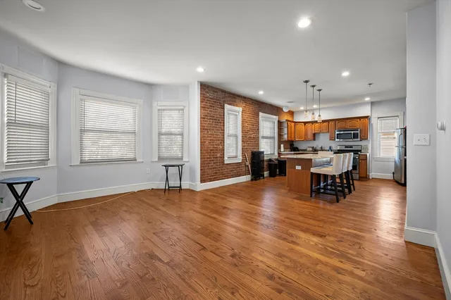 a living room with furniture and large windows