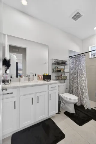 a kitchen with stainless steel appliances granite countertop a sink a stove a refrigerator a center island a stove and a cabinets