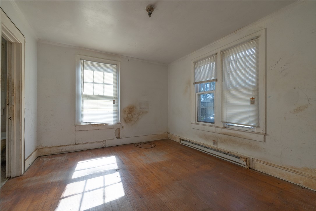 106 Frances Street Anderson, SC 29621 - Photo 11 of 15 This bright room features durable hardwood flooring and large windows, ready for a fresh design.